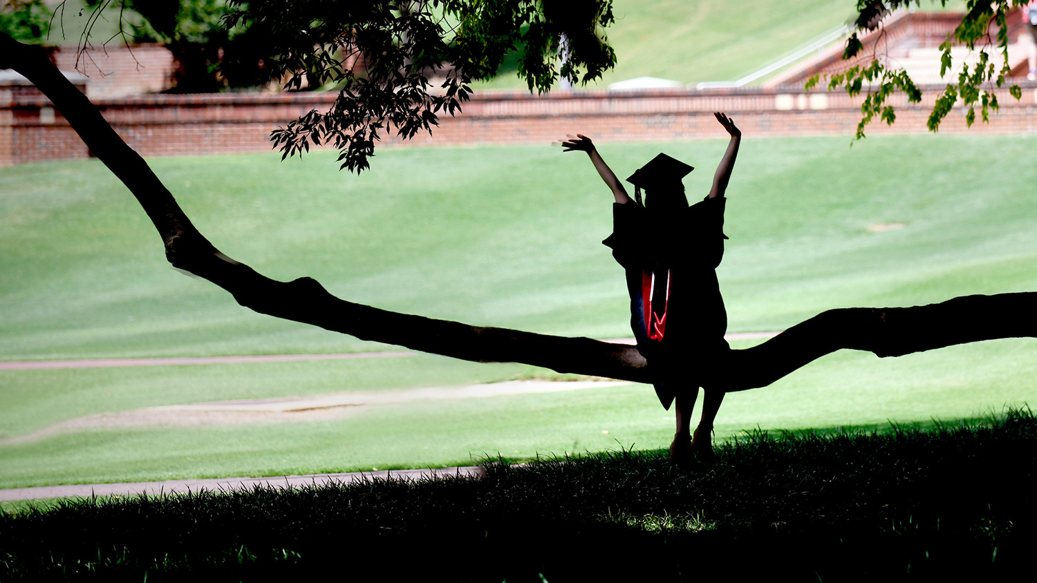 A student poses for photos after graduation