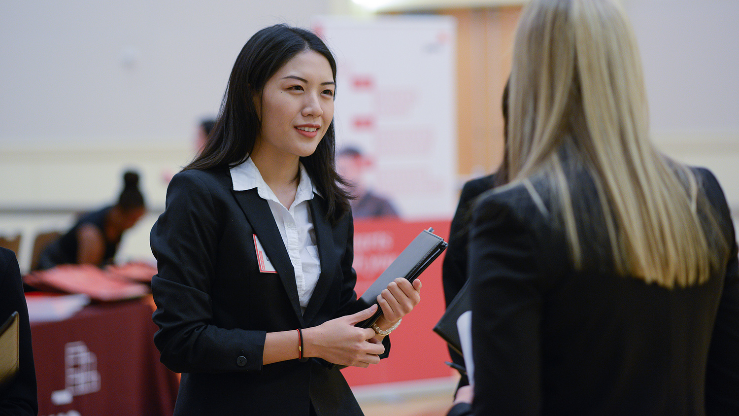 A student talks to a recruiter at a career fair