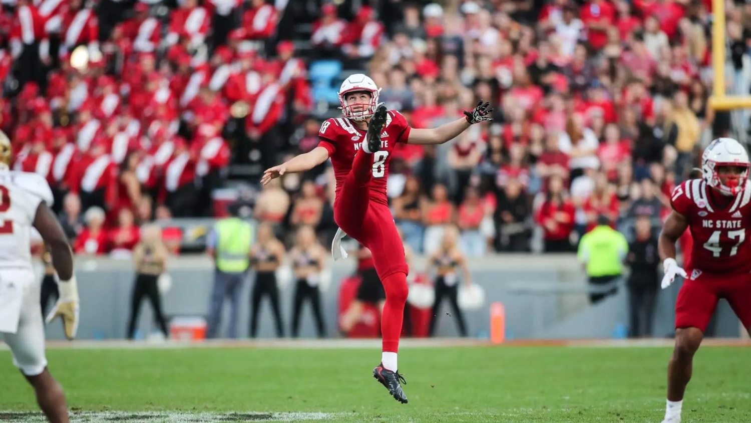 caden noonkester kicking a football during a football game