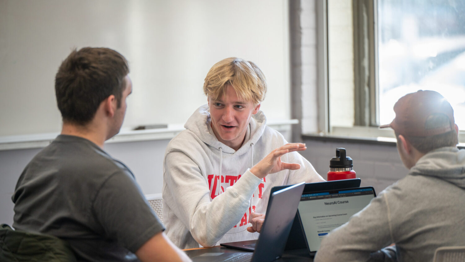 Students talk during a class on campus.